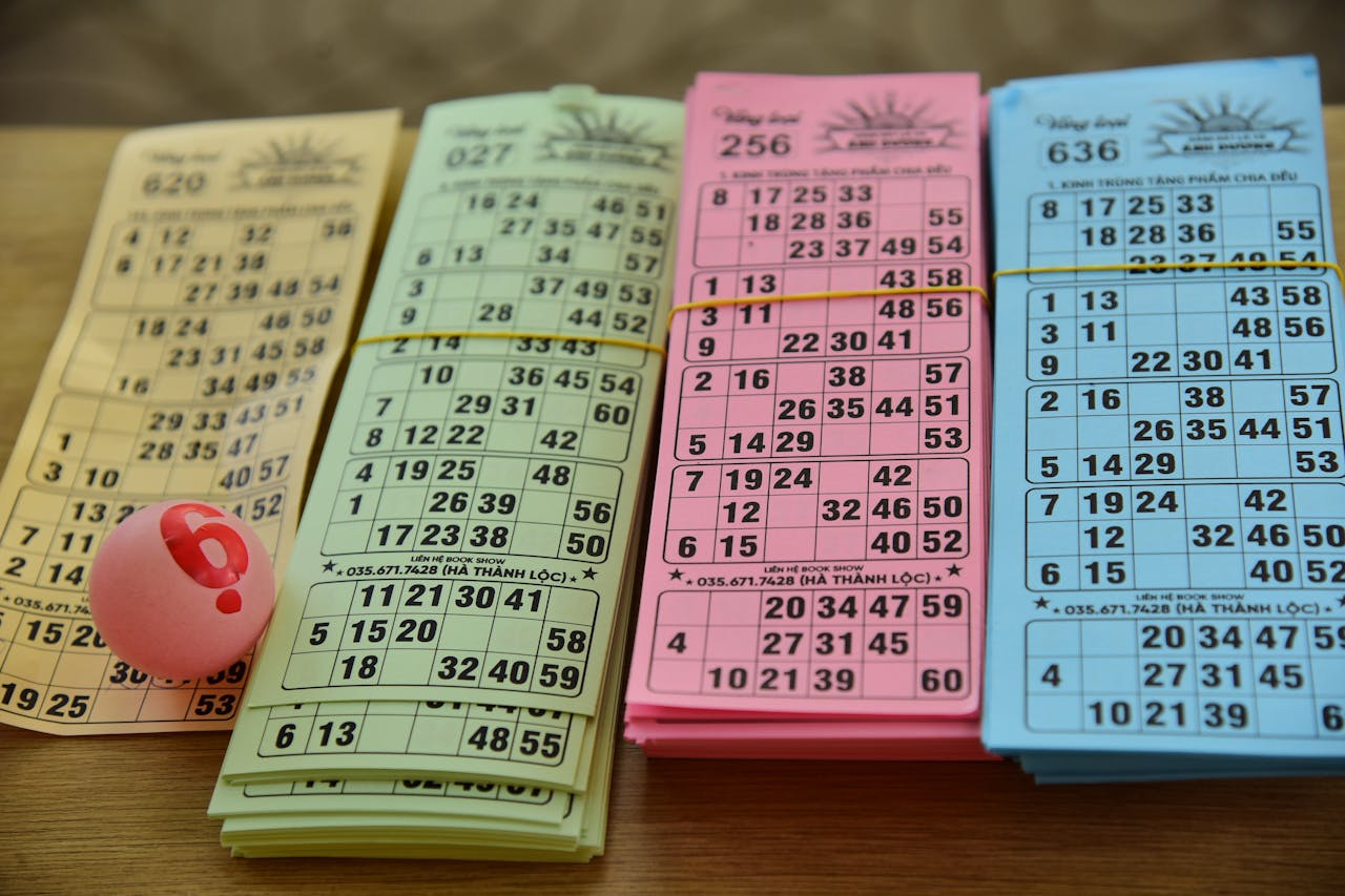 A set of colorful bingo cards and a numbered ball on a table, ready for a game night.